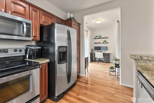 a kitchen with stainless steel appliances a stove a refrigerator and cabinets