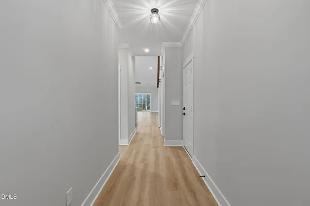 a view of a hallway with wooden floor