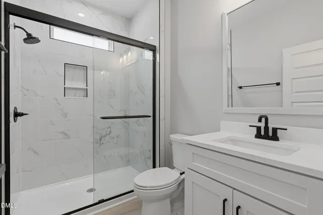 a bathroom with a sink toilet and shower