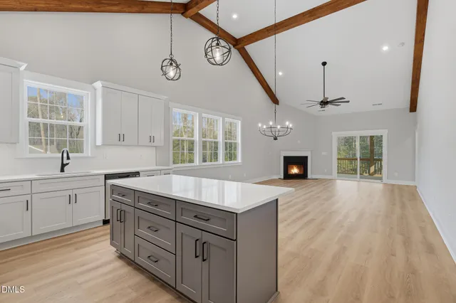a kitchen with granite countertop a sink stainless steel appliances and cabinets
