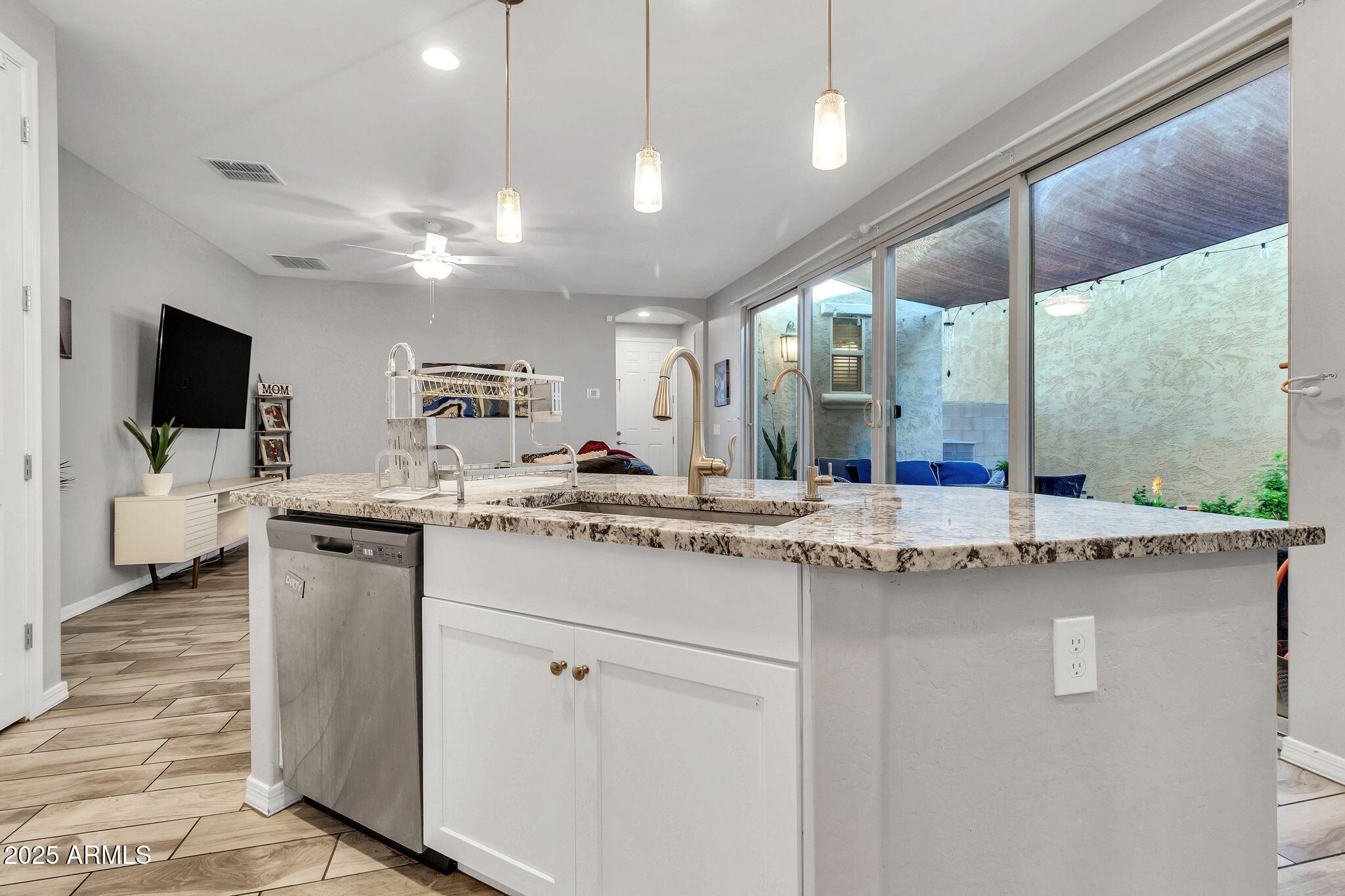 4145 East Bethena Street Gilbert, AZ 85295 - Photo 15 of 60 a kitchen with stainless steel appliances granite countertop a sink and cabinets