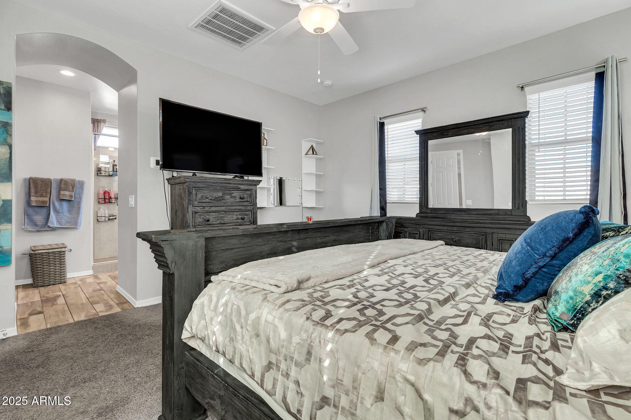 4145 East Bethena Street Gilbert, AZ 85295 - Photo 17 of 60 a bedroom with a bed and a flat screen tv