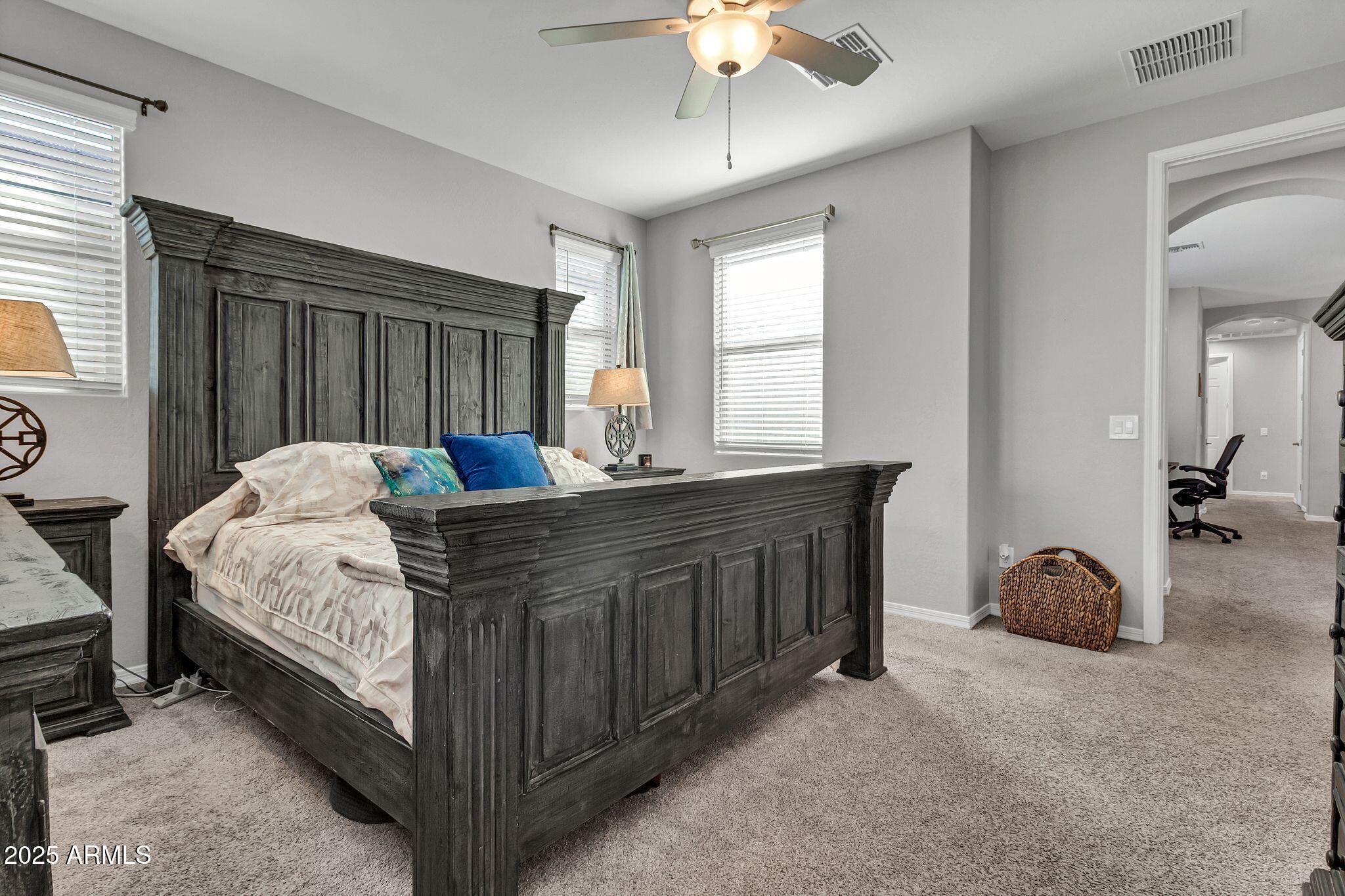 4145 East Bethena Street Gilbert, AZ 85295 - Photo 18 of 60 a bed room with a bed and a chair