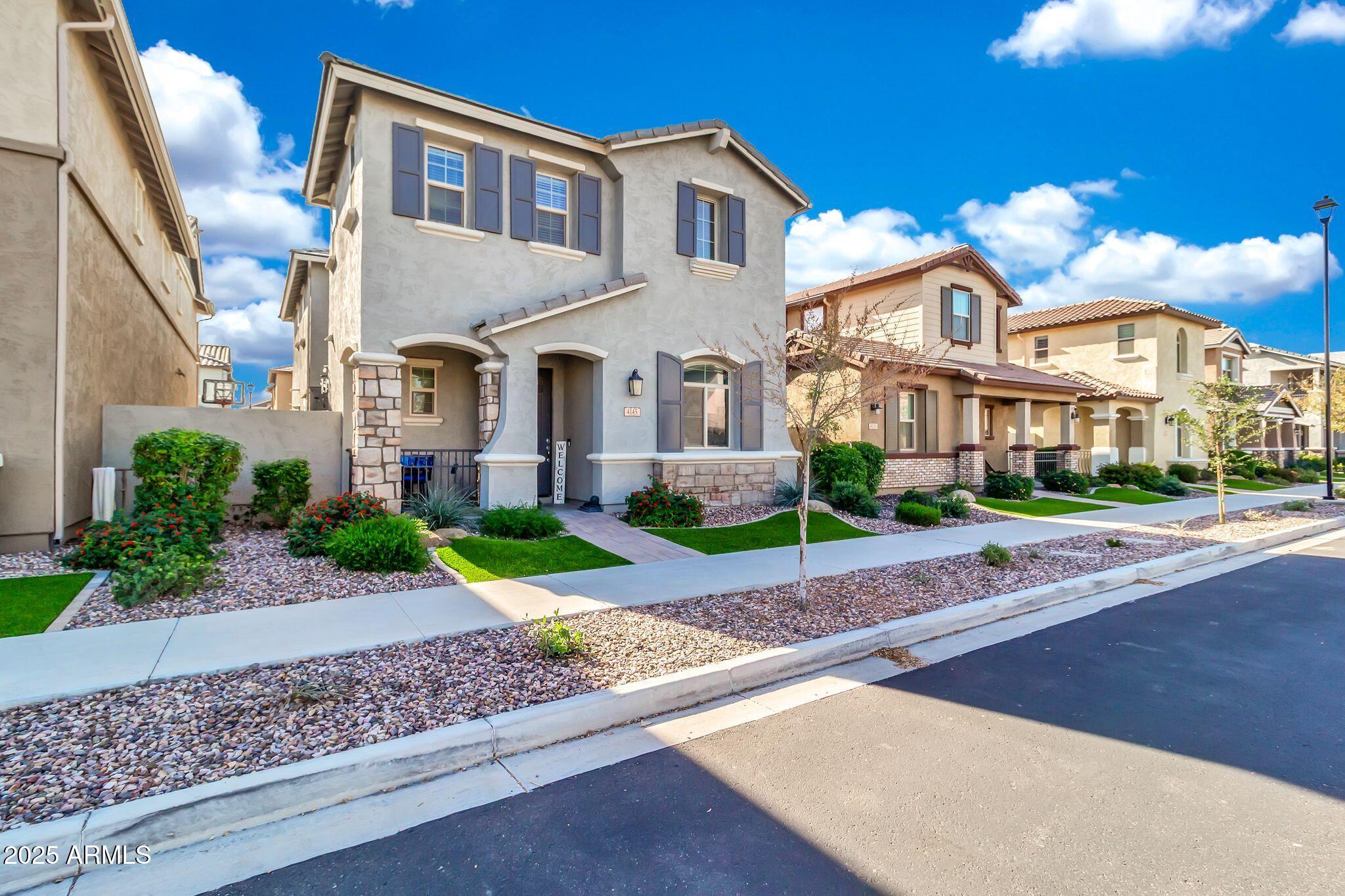 4145 East Bethena Street Gilbert, AZ 85295 - Photo 2 of 60 a front view of house with yard and green space
