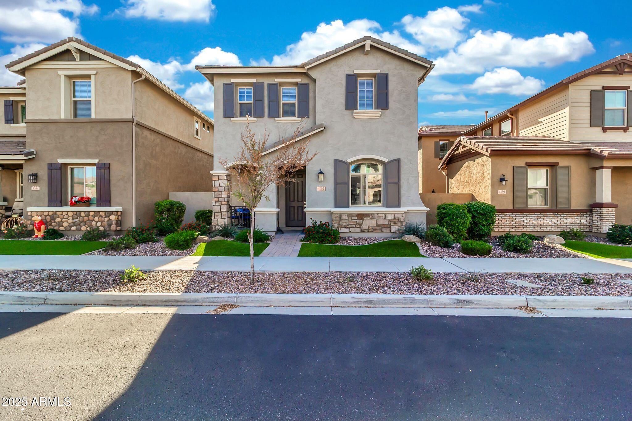 4145 East Bethena Street Gilbert, AZ 85295 - Photo 3 of 60 a front view of a house with a yard and a garage