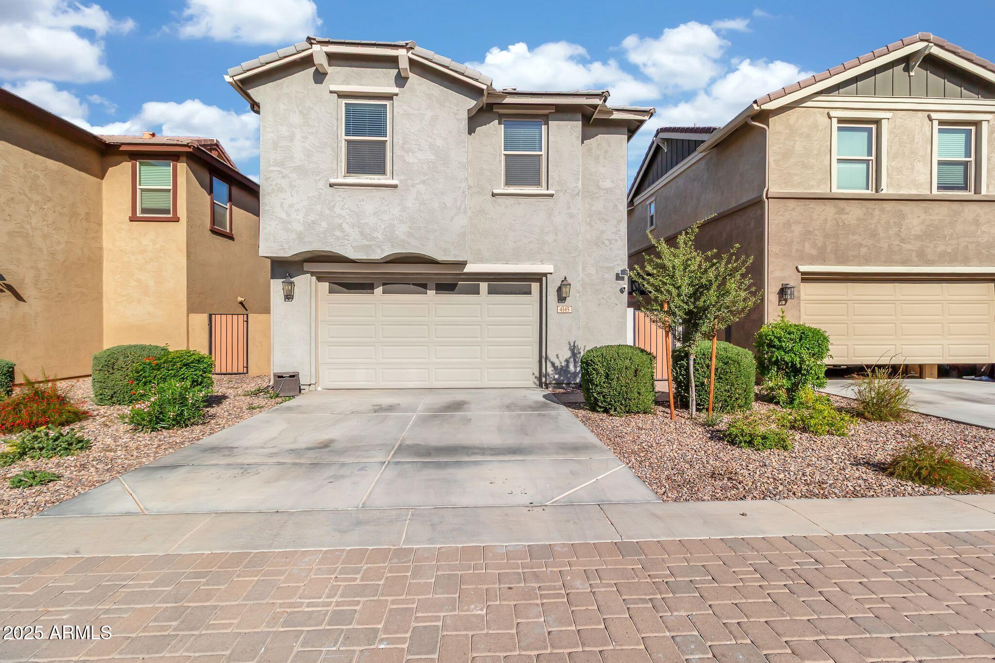 4145 East Bethena Street Gilbert, AZ 85295 - Photo 47 of 60 a front view of a house with a yard and garage