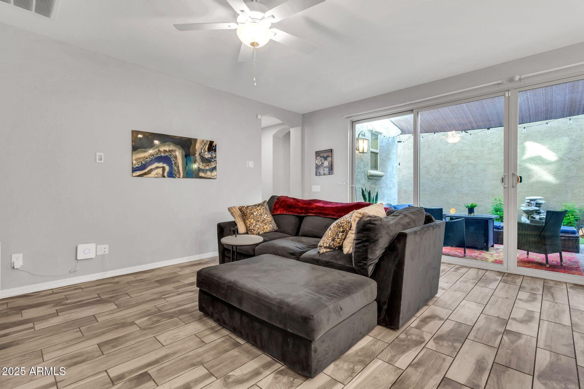 4145 East Bethena Street Gilbert, AZ 85295 - Photo 7 of 60 a living room with furniture and a floor to ceiling window