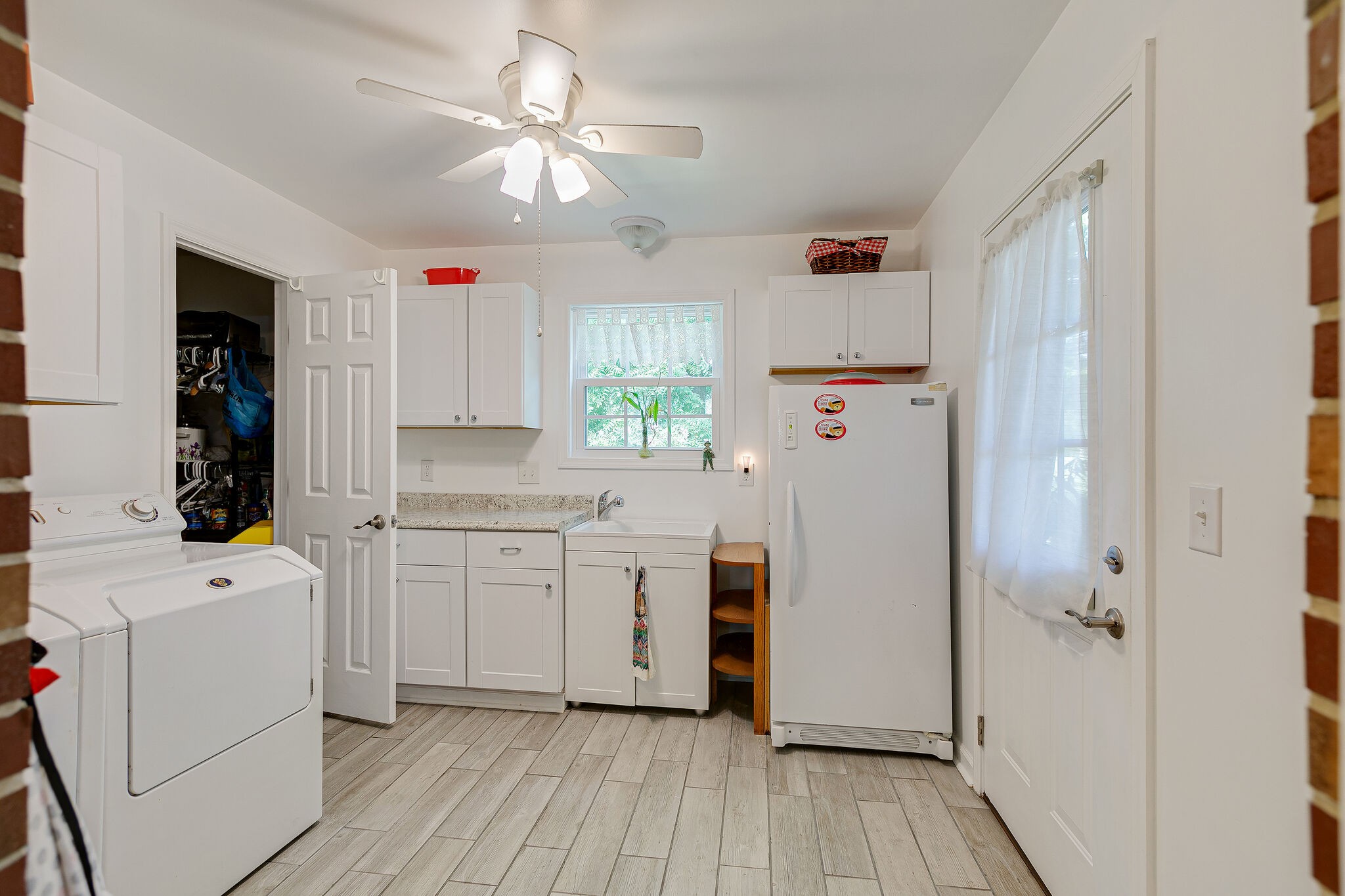 2116 Double Branch Road Columbia, TN 38401 - Photo 16 of 29 a kitchen with a refrigerator a stove and white cabinets