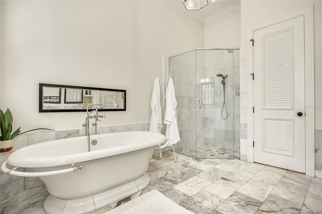 an empty room with wooden floor a ceiling fan and windows