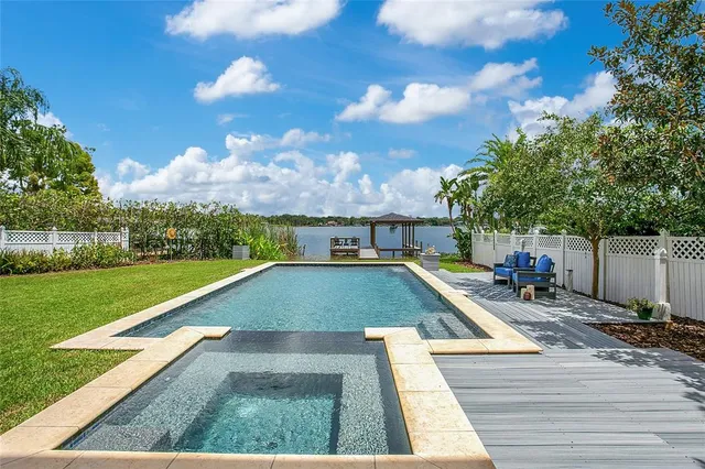 a view of a big room with wooden floor and chandelier