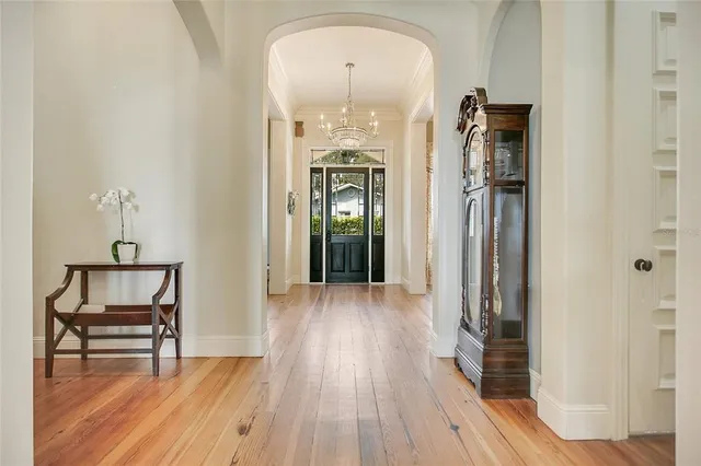 a view of a dining room with furniture wooden floor and chandelier