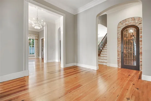 a spacious bedroom with a bed and a wooden floor