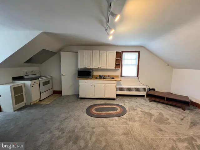 a kitchen with a sink a stove and cabinets