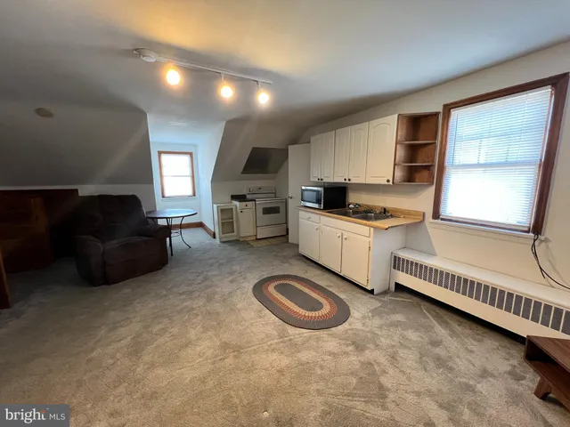 a kitchen with sink refrigerator and cabinets