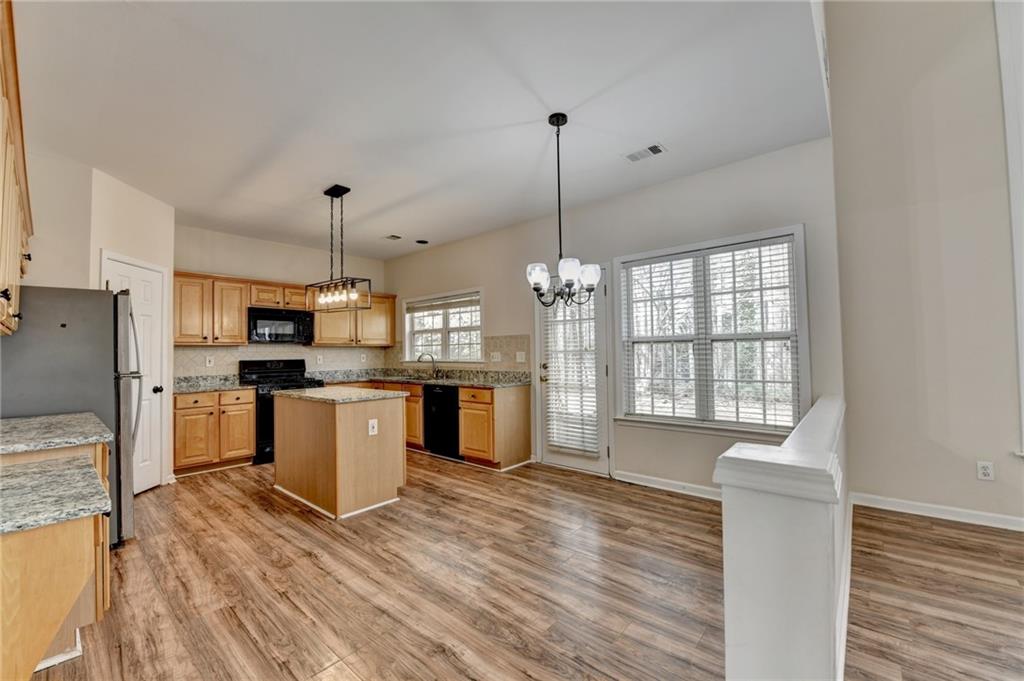 100 Hawnley Trc Northwest Suwanee, GA 30024 - Photo 22 of 58 a kitchen with stainless steel appliances granite countertop a refrigerator a oven a stove and a wooden floors