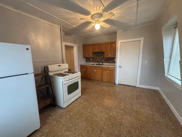 a kitchen with stainless steel appliances a refrigerator a stove a sink and a refrigerator