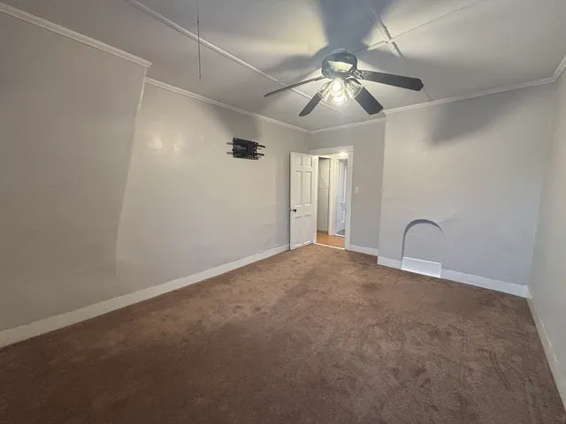 a view of an empty room with a fan