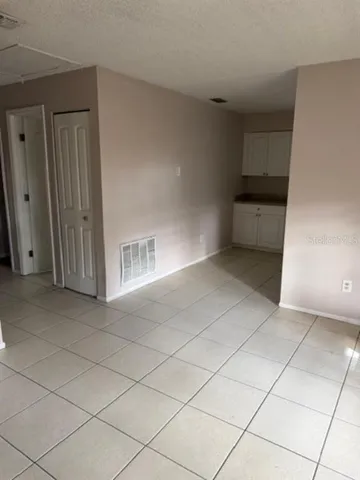 a view of a utility room with cabinets