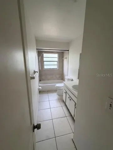 a bathroom with a sink a toilet and a shower