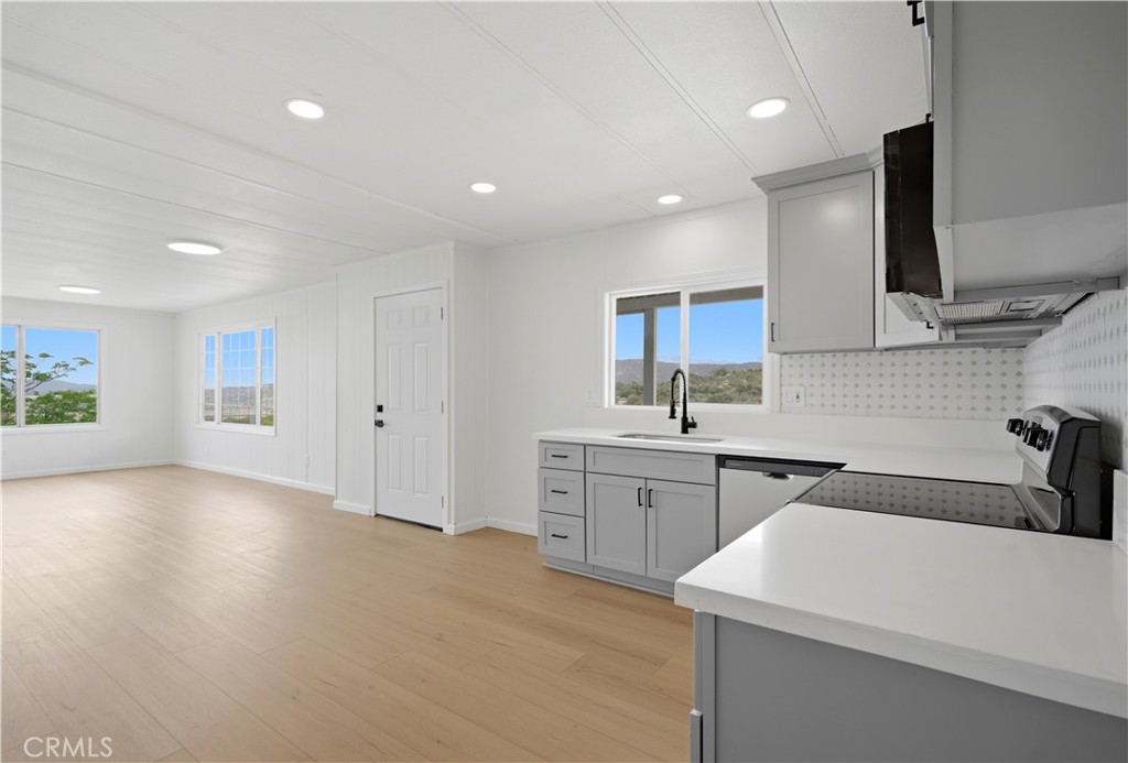 59995 Granite Gulley Road Anza, CA 92539 - Photo 9 of 33 a large white kitchen with a sink