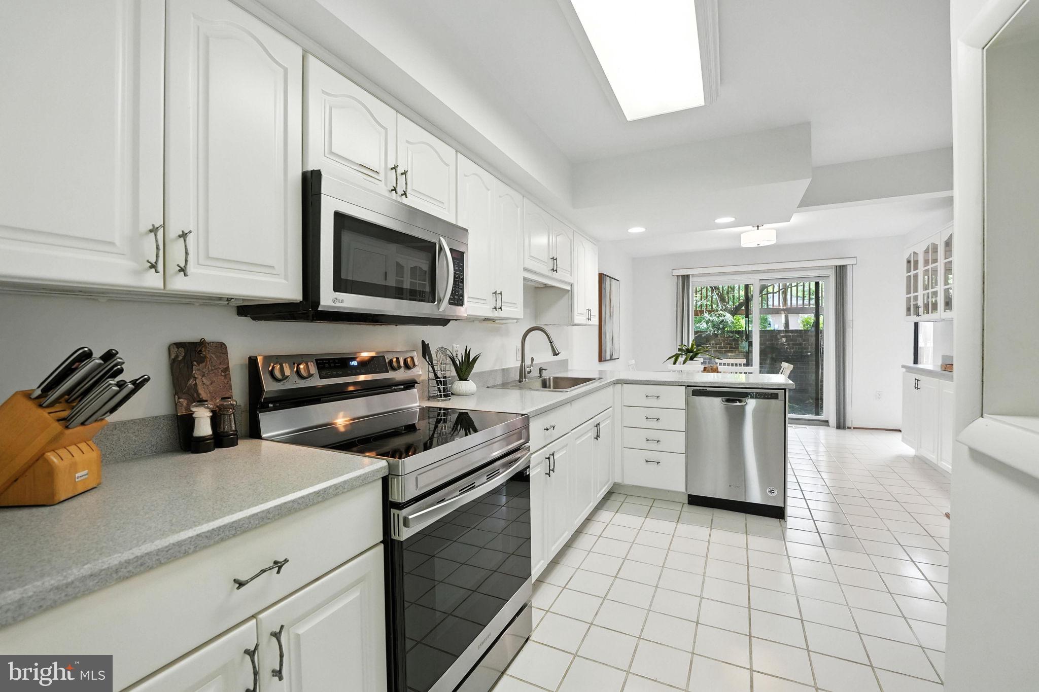 2151 Cabots Point Lane Reston, VA 20191 - Photo 20 of 71 a kitchen with a sink a stove and cabinets