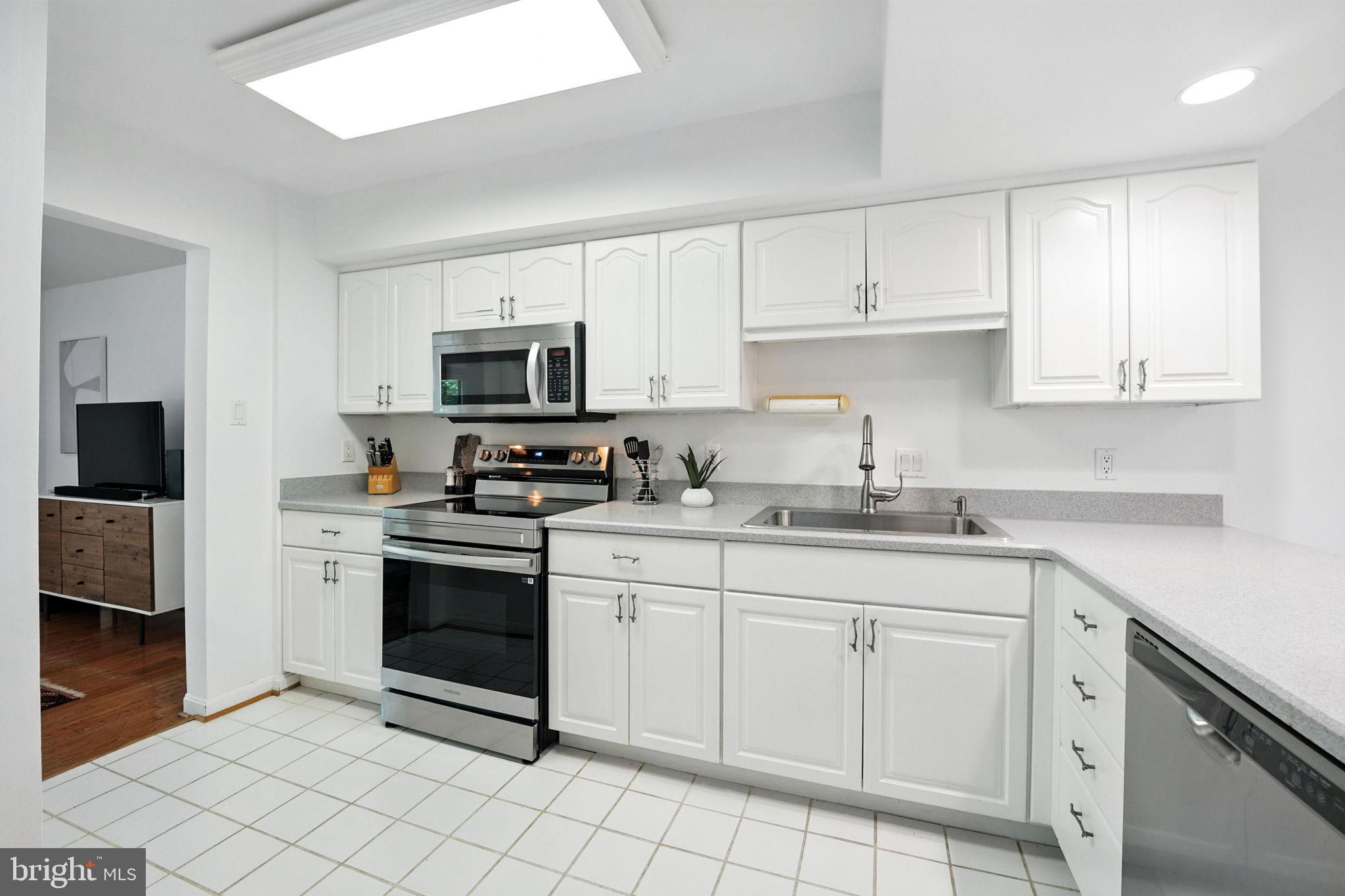 2151 Cabots Point Lane Reston, VA 20191 - Photo 21 of 71 a kitchen with cabinets stainless steel appliances and a sink
