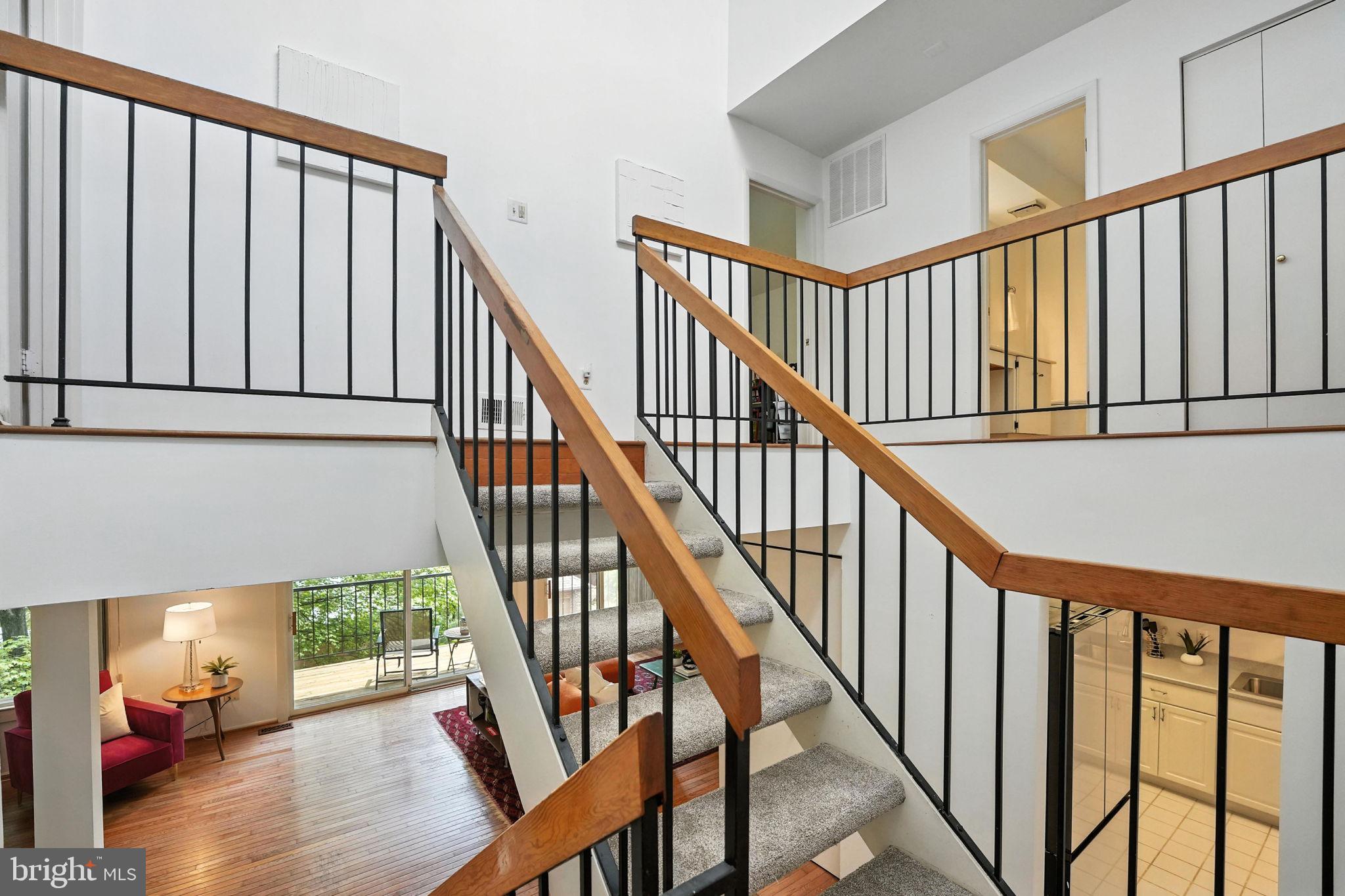 2151 Cabots Point Lane Reston, VA 20191 - Photo 27 of 71 a view of staircase with lots of frames on wall and a wooden floor