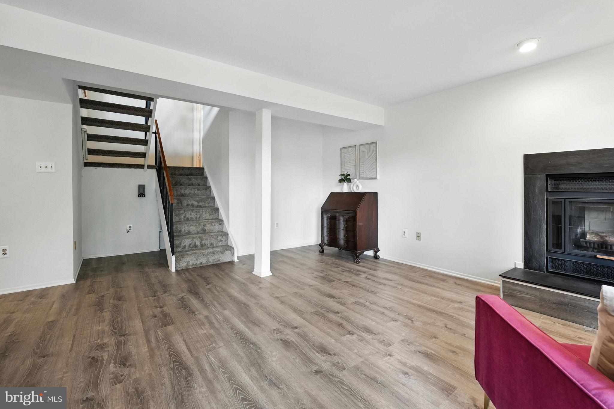 2151 Cabots Point Lane Reston, VA 20191 - Photo 46 of 71 an empty room with wooden floor and fireplace