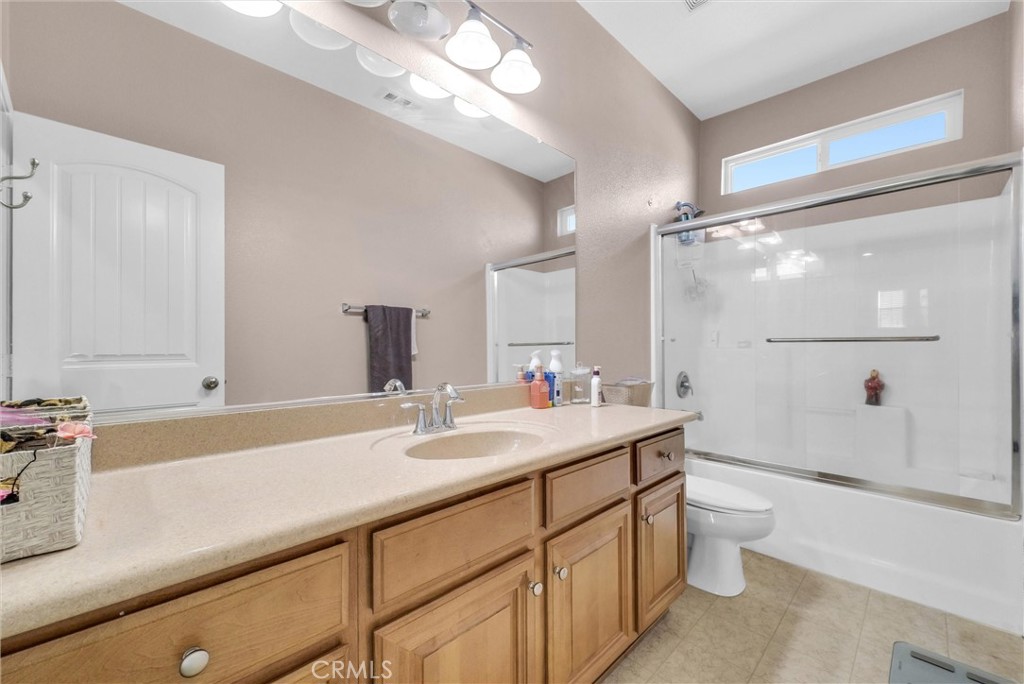 18388 Hidden Ranch Road Riverside, CA 92508 - Photo 35 of 46 a bathroom with a sink a toilet a mirror and shower