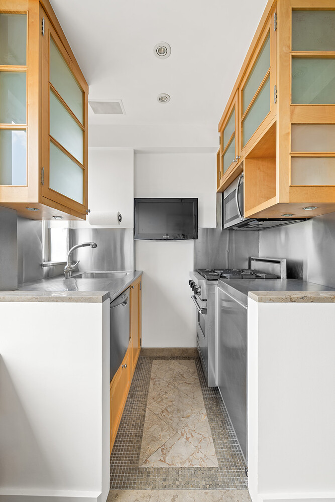 120 Central Park South, Unit 6ABC Manhattan, NY 10019 - Photo 10 of 12 a kitchen with stainless steel appliances granite countertop a sink and a stove