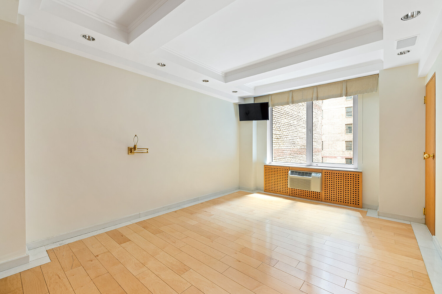 120 Central Park South, Unit 6ABC Manhattan, NY 10019 - Photo 2 of 12 a view of an empty room with a window and a kitchen