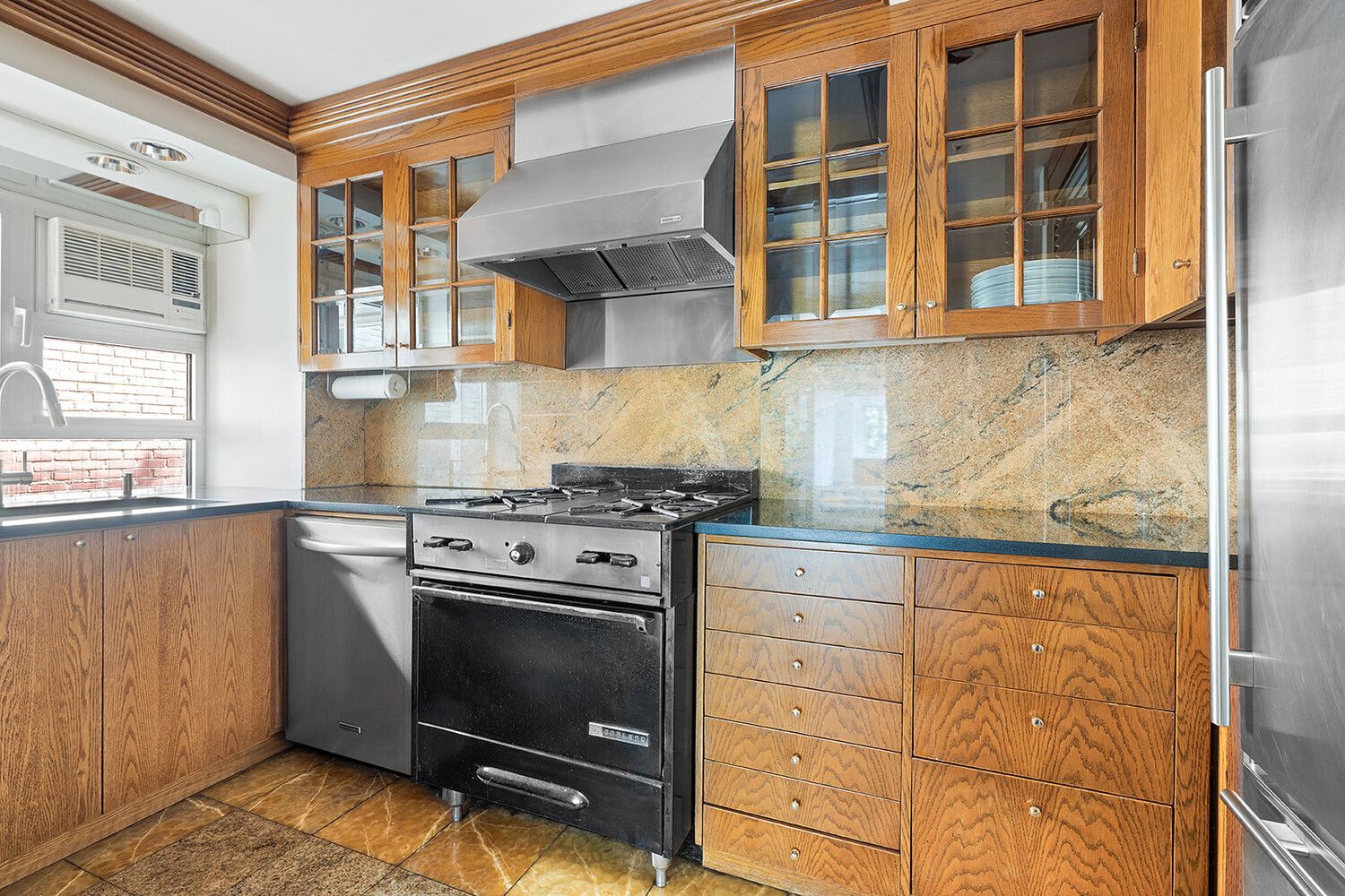 120 Central Park South, Unit 6ABC Manhattan, NY 10019 - Photo 7 of 12 a kitchen with a stove and cabinets