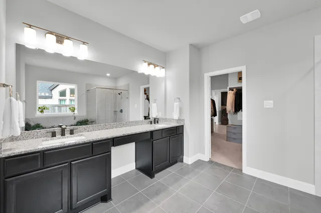 a large bathroom with a double vanity sink and mirror