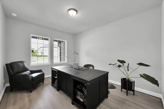 a view of a workspace with furniture and a window