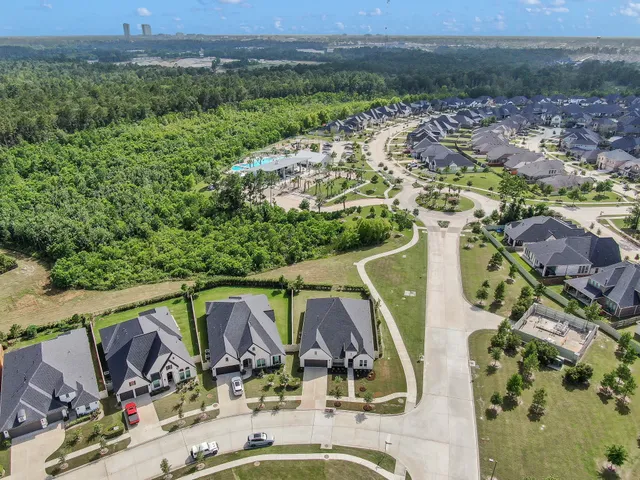an aerial view of a house with garden space and outdoor seating