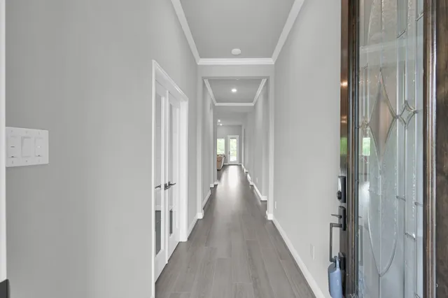 a view of a hallway with a wooden floor