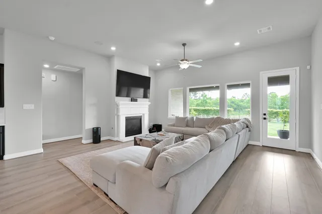a large white bedroom with a bed and a flat screen tv
