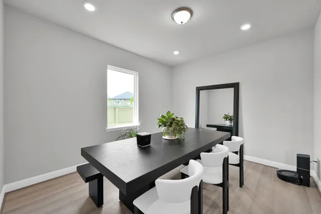 a view of a dining room with furniture and wooden floor