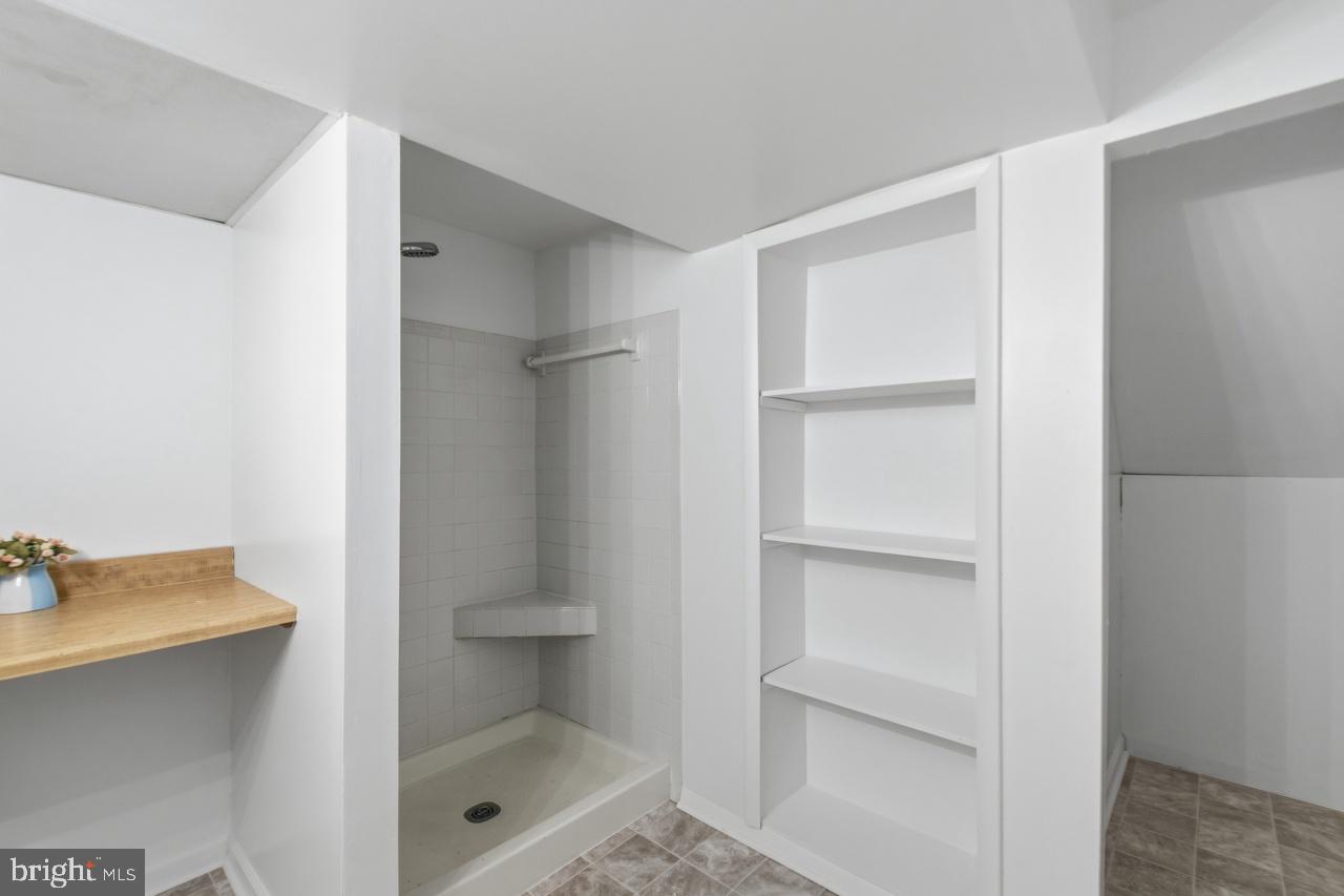 7100 Counter Place Burke, VA 22015 - Photo 47 of 54 Lower level bath shows, shelving storage etc