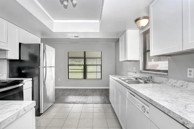 a kitchen with a sink stove and refrigerator