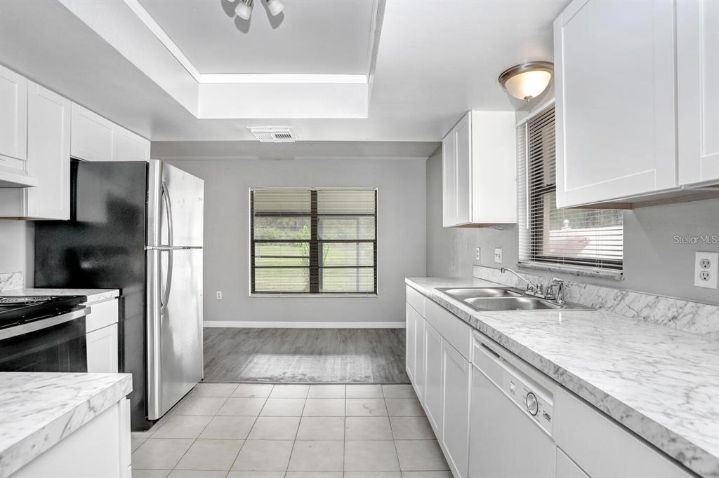 378 Buttonwood Drive Kissimmee, FL 34743 - Photo 12 of 28 a kitchen with a sink stove and refrigerator