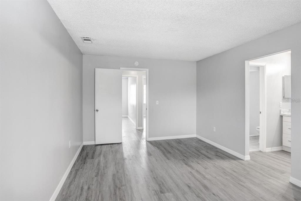 378 Buttonwood Drive Kissimmee, FL 34743 - Photo 14 of 28 a view of an empty room with wooden floor and closet