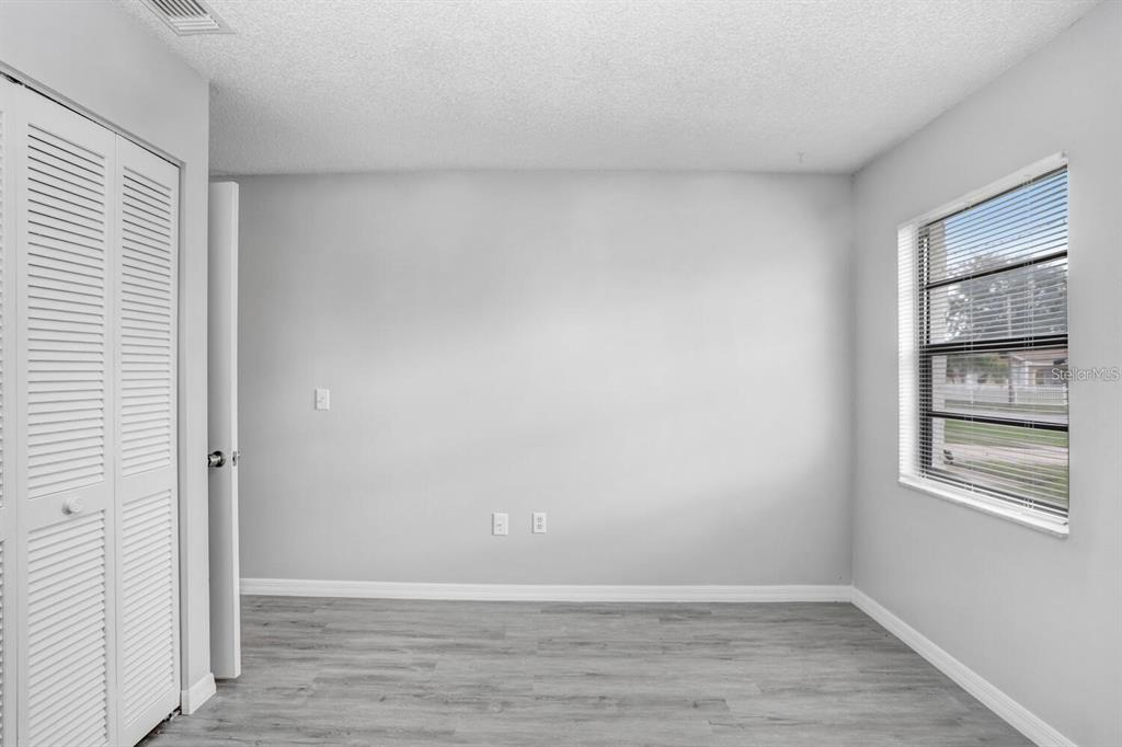 378 Buttonwood Drive Kissimmee, FL 34743 - Photo 18 of 28 a view of an empty room with wooden floor and a window
