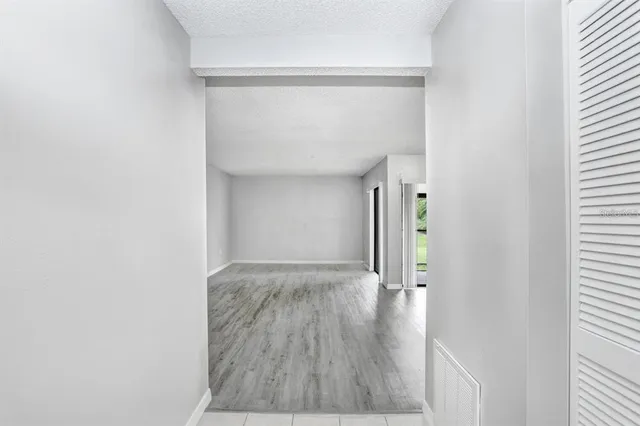 a view of hallway with wooden floor