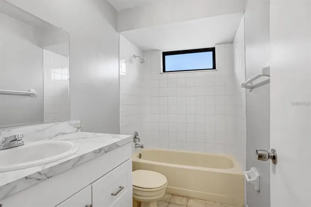 a bathroom with a sink a toilet and bathtub