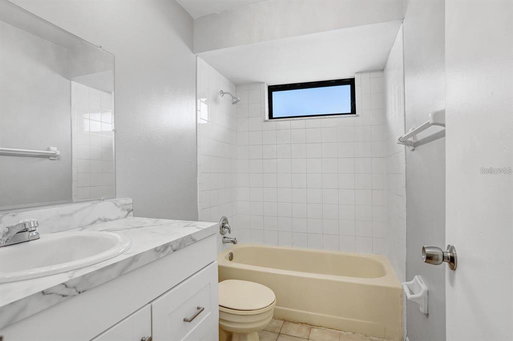 378 Buttonwood Drive Kissimmee, FL 34743 - Photo 21 of 28 a bathroom with a sink a toilet and bathtub