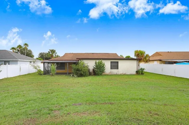 a view of a house with a backyard
