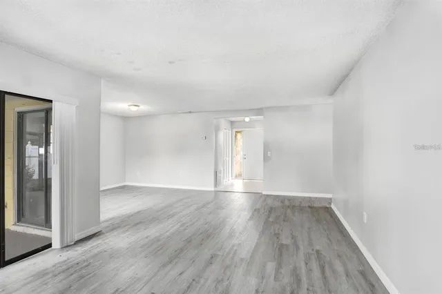 a view of an empty room and wooden floor