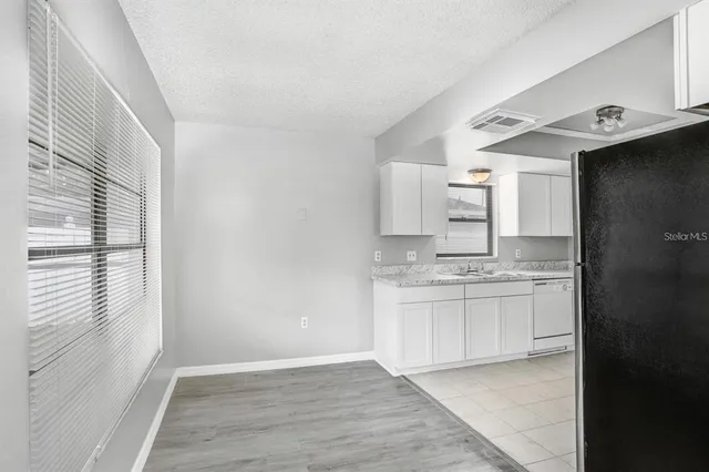 a bathroom with granite countertop a sink and a stove