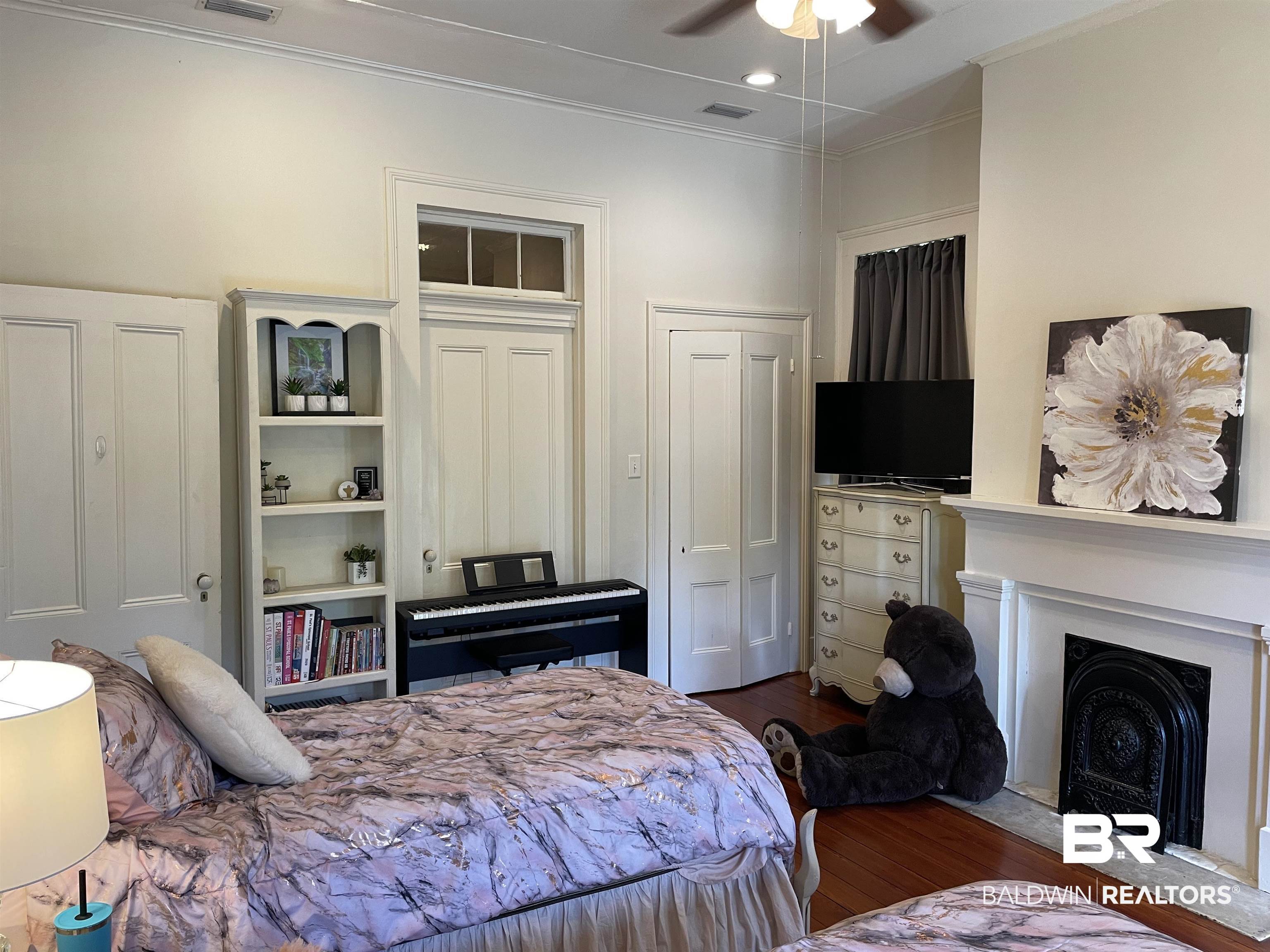 1001 Augusta Street Mobile, AL 36604 - Photo 5 of 26 Bedroom featuring ornamental molding, dark hardwood / wood-style floors, and ceiling fan